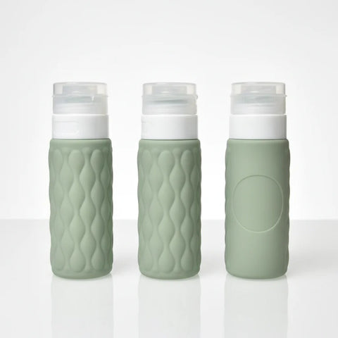 imgi_12_Three_sage_green_diamond_textured_silicone_travel_bottles_showing_front_side_and_back_angles_on_white_background
