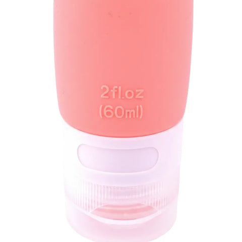 imgi_5_Close-up_of_2_fl_oz_60ml_embossed_measurement_text_and_clear_bottom_cap_on_coral_pink_silicone_travel_bottle